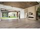 Open floor plan with wood ceiling, sliding doors, marble fireplace, and seamless indoor/outdoor flow at 8386 E Leaning Rock Rd, Scottsdale, AZ 85266