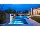 A luxurious pool and spa at dusk features a fire pit, pergola, and a modern home in the background at 8386 E Leaning Rock Rd, Scottsdale, AZ 85266