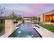 A backyard with a pool, spa, and travertine tile in a modern home setting at 8386 E Leaning Rock Rd, Scottsdale, AZ 85266