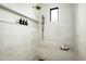This modern shower features white tile, a built-in bench, and recessed shelving for toiletries at 8386 E Leaning Rock Rd, Scottsdale, AZ 85266