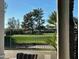 Beautiful golf course view from the patio with lush green grass and mature trees on a sunny day at 12028 N 80Th Pl, Scottsdale, AZ 85260