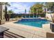 A beautiful backyard pool with potted plants and palm trees creates a relaxing outdoor oasis at 12028 N 80Th Pl, Scottsdale, AZ 85260