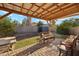 Cozy covered patio with brick pavers and comfortable seating perfect for outdoor relaxation and entertaining in the landscaped yard at 723 E Gold Dust Way, San Tan Valley, AZ 85143