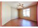 Bright bedroom with hardwood floors and ceiling fan at 19403 N Ponderosa Ct, Surprise, AZ 85387
