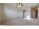 Bedroom with carpet flooring, ceiling fan, and walk-in closet at 19403 N Ponderosa Ct, Surprise, AZ 85387