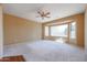 Spacious bedroom with bay window and ceiling fan at 19403 N Ponderosa Ct, Surprise, AZ 85387