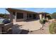 Home exterior showcasing a large patio and well-manicured landscaping at 19403 N Ponderosa Ct, Surprise, AZ 85387