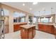 Spacious kitchen with granite island, ample cabinetry, and stainless steel appliances at 19403 N Ponderosa Ct, Surprise, AZ 85387