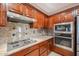 Open kitchen with granite countertops and breakfast bar at 19403 N Ponderosa Ct, Surprise, AZ 85387