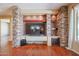 Elegant living room featuring a stone fireplace and built-in entertainment center at 19403 N Ponderosa Ct, Surprise, AZ 85387