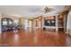 Living room with hardwood floors, stone fireplace, and built-in entertainment center at 19403 N Ponderosa Ct, Surprise, AZ 85387