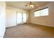 Well-lit bedroom with carpet floors and double doors opening to backyard at 3614 W Krall St, Phoenix, AZ 85019