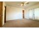 Bright bedroom featuring carpet flooring and double doors leading to the outdoors at 3614 W Krall St, Phoenix, AZ 85019