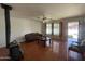 Open living area featuring a rustic wood-burning stove, ceiling fan, and tile floors at 3614 W Krall St, Phoenix, AZ 85019