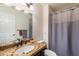 Bathroom has granite vanity, large mirror, and shower/tub combo at 6334 N 19Th St, Phoenix, AZ 85016