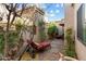 Landscaped courtyard with brick paving and comfortable lounge chair at 6334 N 19Th St, Phoenix, AZ 85016