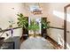 Bright sitting room with large windows, plants, and a chandelier at 6334 N 19Th St, Phoenix, AZ 85016