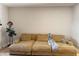 Mustard-colored sectional sofa dominates this living room at 1601 N Saba St # 321, Chandler, AZ 85225