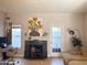 Living room features a fireplace, large artwork, and access to a patio at 1601 N Saba St # 321, Chandler, AZ 85225