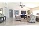 Spacious living room with tile flooring, comfortable seating, and large windows at 8053 E Natal Ave, Mesa, AZ 85209