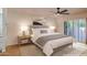 Cozy bedroom with wood floors and access to a patio. Virtually staged at 8230 E Via De La Escuela --, Scottsdale, AZ 85258