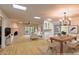 Bright living room with fireplace and dining area, hardwood floors, virtually staged at 8230 E Via De La Escuela --, Scottsdale, AZ 85258