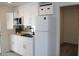 Modern kitchen with white cabinets and appliances at 11275 N 99Th Ave # 14, Peoria, AZ 85345