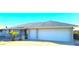 Ranch style home with two-car garage and landscaped front yard at 8203 E Nopal Ave, Mesa, AZ 85209