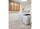 Laundry room with washer, dryer, and cabinets at 8203 E Nopal Ave, Mesa, AZ 85209