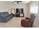 Living room features comfy recliner chairs and a large TV at 8203 E Nopal Ave, Mesa, AZ 85209