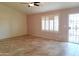 Bright living room featuring tile floors and window shutters at 8203 E Nopal Ave, Mesa, AZ 85209