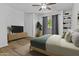 Bright bedroom with a ceiling fan, a sliding glass door, and built-in shelving at 3845 E Greenway Rd # 131, Phoenix, AZ 85032