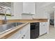 The kitchen has stainless steel sink, wood countertops, white cabinets, and a dishwasher at 3845 E Greenway Rd # 131, Phoenix, AZ 85032