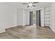 Bright living room featuring wood-look floors, ceiling fan and sliding door to patio at 3845 E Greenway Rd # 131, Phoenix, AZ 85032