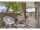 Outdoor patio space with two white chairs at 3845 E Greenway Rd # 131, Phoenix, AZ 85032