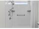 Walk-in shower with grab bar, bench and white tile at 3845 E Greenway Rd # 131, Phoenix, AZ 85032