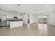 Open-concept living area with tile flooring, modern kitchen, and sliding door to backyard at 1648 N Camden Dr, Florence, AZ 85132