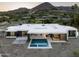 Contemporary home with pool and patio, nestled amidst desert landscape and surrounding neighborhood at 6623 N Hillside Dr, Paradise Valley, AZ 85253
