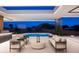 Luxurious outdoor space with a sparkling pool, comfortable seating, and stunning mountain views at 6623 N Hillside Dr, Paradise Valley, AZ 85253