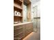 Stylish bathroom with modern wood vanity, marble shower, and sleek gold hardware at 6623 N Hillside Dr, Paradise Valley, AZ 85253