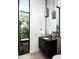Contemporary bathroom featuring a sleek black vanity and eye-catching pendant lighting at 6623 N Hillside Dr, Paradise Valley, AZ 85253