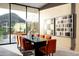 Modern dining room features sleek table, stylish chairs, contemporary artwork and expansive mountain views at 6623 N Hillside Dr, Paradise Valley, AZ 85253