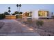 Modern home with desert landscaping, featuring a long driveway and a three car garage at 6623 N Hillside Dr, Paradise Valley, AZ 85253