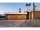 Modern garage with sleek wood doors and subtle exterior lighting, showcasing contemporary design at 6623 N Hillside Dr, Paradise Valley, AZ 85253