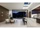 Open-concept kitchen and dining area featuring a modern island, sleek cabinetry, and access to outdoor living spaces at 6623 N Hillside Dr, Paradise Valley, AZ 85253