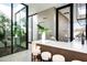 Modern kitchen with a bar counter, with the outdoors visible through windows and skylights, for an airy feel at 6623 N Hillside Dr, Paradise Valley, AZ 85253