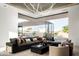 Modern living room with large sectional sofa, floor-to-ceiling windows, and unique light fixture at 6623 N Hillside Dr, Paradise Valley, AZ 85253