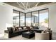 Modern living room with large sectional sofa, floor-to-ceiling windows, and unique light fixture at 6623 N Hillside Dr, Paradise Valley, AZ 85253