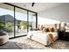 Sunlit main bedroom with large windows, plush rug, and comfortable, neutral-toned furnishings at 6623 N Hillside Dr, Paradise Valley, AZ 85253