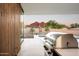 Outdoor cooking station with stunning views of the backyard, pool, and desert landscape at 6623 N Hillside Dr, Paradise Valley, AZ 85253
